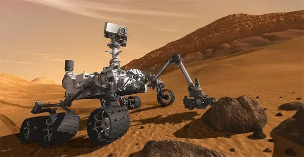 The Martian explorer robot Perserverance framed against the alien backdrop of the red planet.